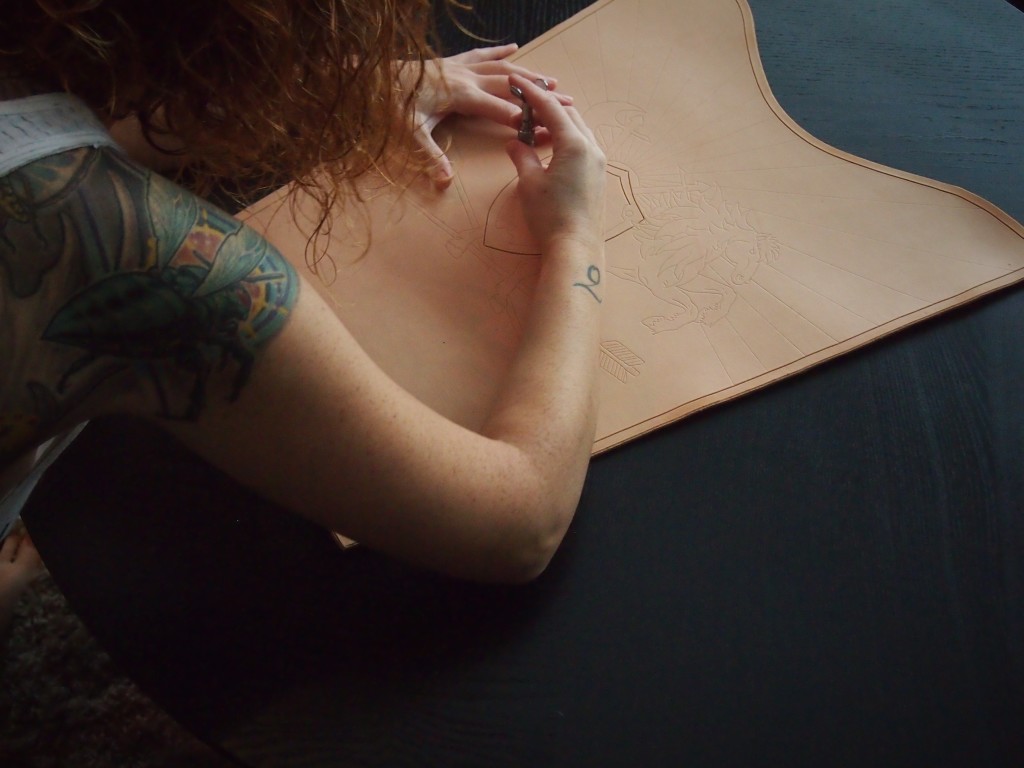Using the swivel knife to cut out the art in the leather quiver
