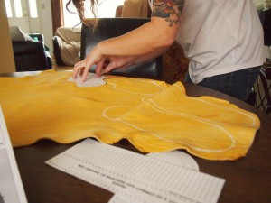 Tracing the moccasin pattern onto the moose hide