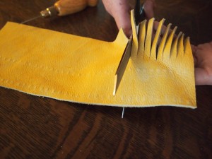 Cutting up the fringe for the moose hide moccasins