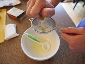 Juicing a lemon for making dandelion jelly