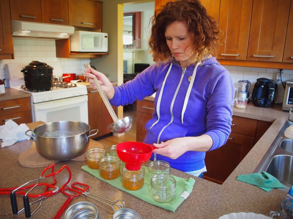 Pouring the dandelion jelly into jars