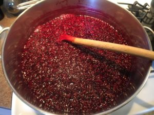 Cooking the blackberries to make blackberry basil jam